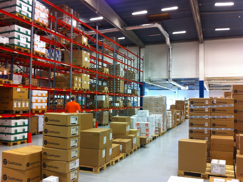 Entrepôt de garde-meuble avec cartons empilés et boxes de stockage sécurisés